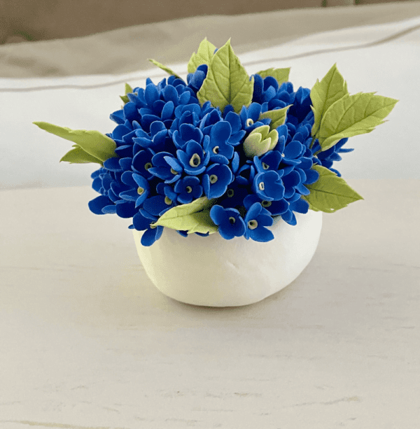 Forget- me - not flowers in white vase