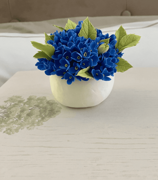 blue flowers in white vase